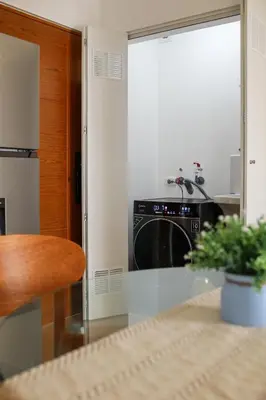 a kitchen with a black dishwasher and a table at Brand new apartment in Olivar of San Felipe in Lima