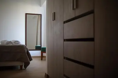 a bedroom with a bed and a dresser with a mirror at Brand new apartment in Olivar of San Felipe in Lima