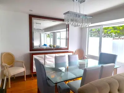 a dining room with a glass table and chairs at Apartment modern full 3BR near Larcomar, Miraflores, Lima, Peru Sunset all days in Lima