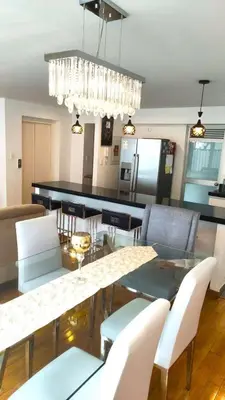 a dining room and living room with a table and chairs at Apartment modern full 3BR near Larcomar, Miraflores, Lima, Peru Sunset all days in Lima