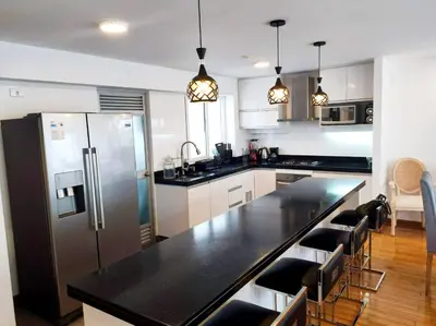 a kitchen with a black counter top and a refrigerator at Apartment modern full 3BR near Larcomar, Miraflores, Lima, Peru Sunset all days in Lima