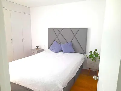 a bedroom with a large bed with purple pillows at Apartment modern full 3BR near Larcomar, Miraflores, Lima, Peru Sunset all days in Lima