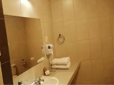 a bathroom with a sink and a mirror at Belle Sand Hotel in Ica