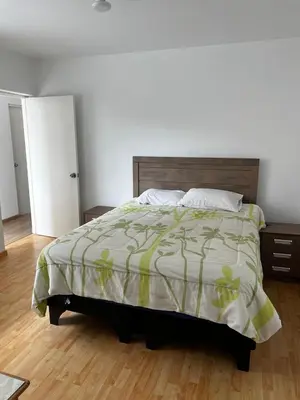 a bedroom with a large bed and a wooden floor at Amplio y acogedor departamento de 130m2 - 2do piso in Lima