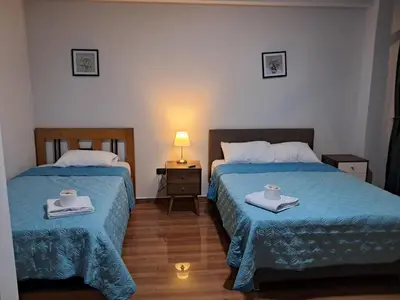 a bedroom with two beds with towels and a lamp at Alojamiento Flower House in San Antonio