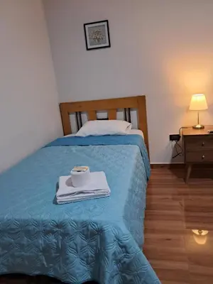 a bedroom with a bed with a tray with a cup on it at Alojamiento Flower House in San Antonio