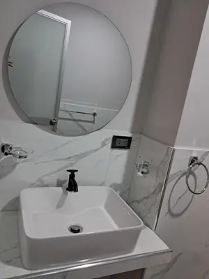 a bathroom with a white sink and a mirror at Alojamiento Flower House in San Antonio