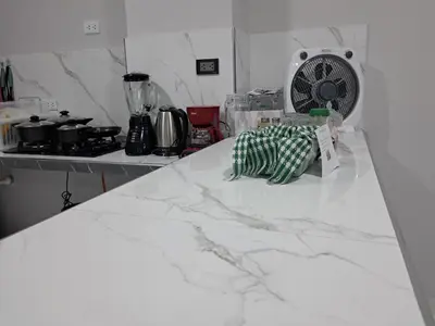 a kitchen counter with a white marble counter top at Alojamiento Flower House in San Antonio