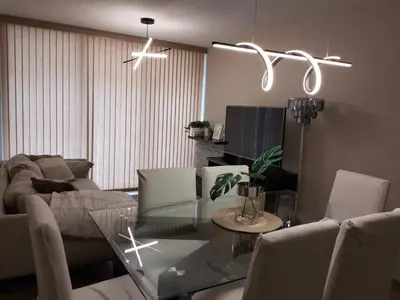 a living room with a glass table and a couch at Adriana in Lima