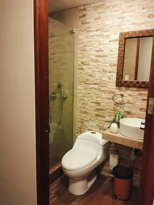 a bathroom with a toilet and a sink and a shower at Adriana in Lima