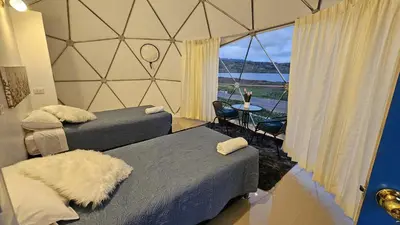 a room with two beds and a window with a view at Sky domos - laguna huaypo in Anta