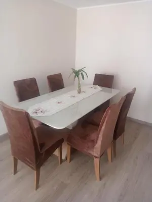 a dining room table and chairs with a plant on it at Alto Alborada Cercado in Lima