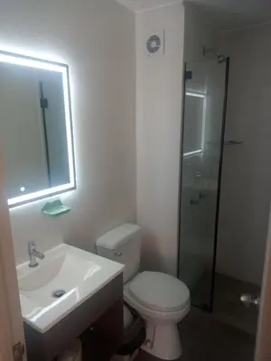 a bathroom with a toilet and a sink and a shower at Alto Alborada Cercado in Lima