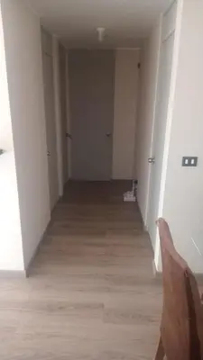 an empty hallway of an apartment with a wooden floor at Alto Alborada Cercado in Lima