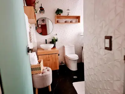 a small bathroom with a toilet and a sink at Arins House in Cusco