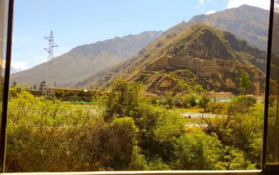 a view of a mountain from a train window at Tambo de Ollantay Hotel in Ollantaytambo