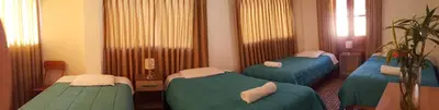 a hospital room with three beds in it at Tambo de Ollantay Hotel in Ollantaytambo