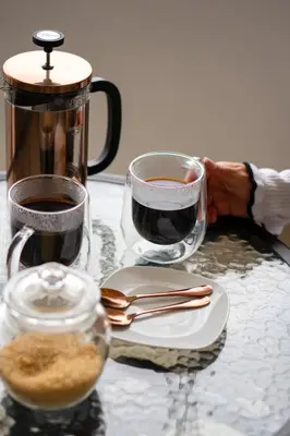 two glasses of coffee sitting on a table at Huaral House in Huaral