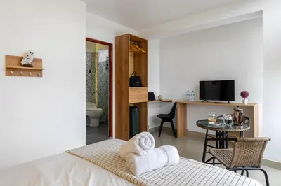 a bedroom with a bed and a table with a dining room at Huaral House in Huaral