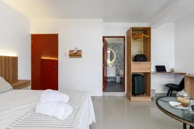 a bedroom with a bed and a table with towels at Huaral House in Huaral