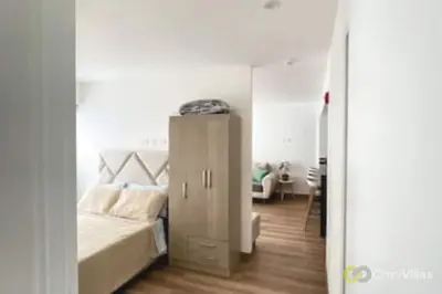 a bedroom with a bed and a small cabinet at Elegant and cozy 2BR in Miraflores by Eco28 in Lima
