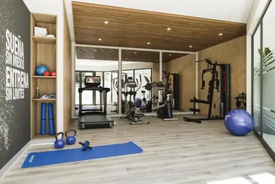 a gym with several treadmills and machines in a room at Elegant and cozy 2BR in Miraflores by Eco28 in Lima