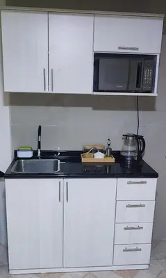 a kitchen with a sink and a microwave at Monoambiente a 20 minutos del Aeropuerto, moderno y privado in Lima