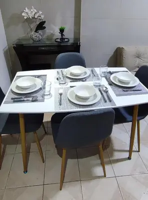 a white table with chairs and plates on it at Monoambiente a 20 minutos del Aeropuerto, moderno y privado in Lima