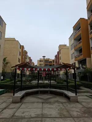 a pavilion in the middle of a courtyard with buildings at Apartamento en condominio cerca a Plaza Norte in Lima