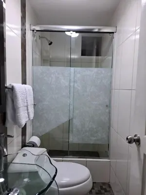 a bathroom with a shower with a toilet and a sink at Apartamento en condominio cerca a Plaza Norte in Lima