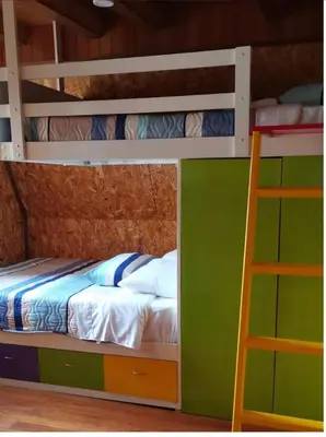 a bunk bed with a ladder in a room at La Cabaña del Tony in Villa Rica