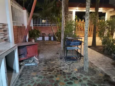 an outdoor patio with a table and a stove at La Cabaña del Tony in Villa Rica