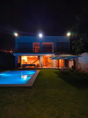 a house with a swimming pool at night at La Morada del Sol in Cieneguilla