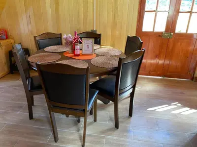 a dining room table with chairs and a table and a table at Cabañas Don Ceferino in Palmira