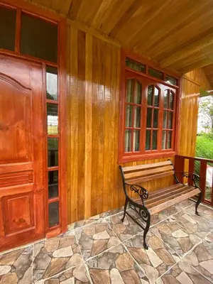 a bench sitting on the porch of a house at Cabañas Don Ceferino in Palmira