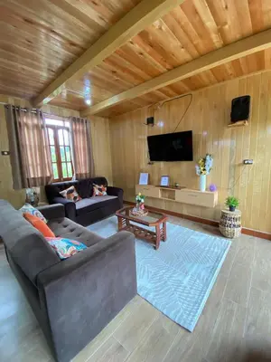 a living room with a couch and a tv at Cabañas Don Ceferino in Palmira