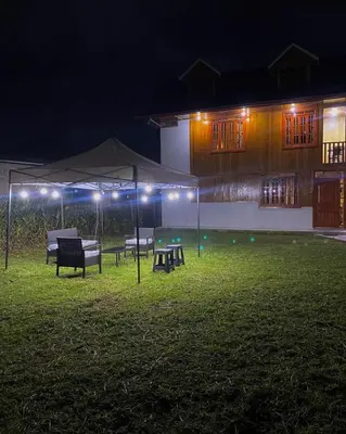 a group of benches in a yard at night at Cabañas Don Ceferino in Palmira