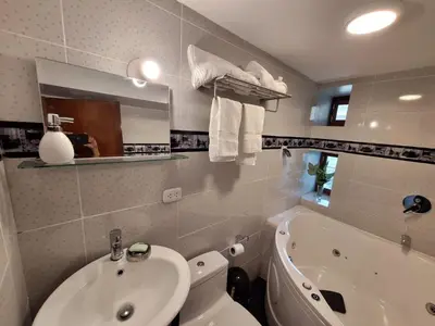 a bathroom with a sink and a toilet and a tub at Country house in nature in Sacred Valley in Huayllabamba