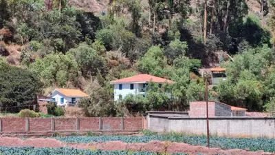 a group of houses on the side of a hill at Cottage in nature in Sacred Valley with mountain views in Huayllabamba