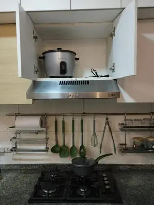 a kitchen with a stove with a pot on the wall at Panoramic view apartment in Lima