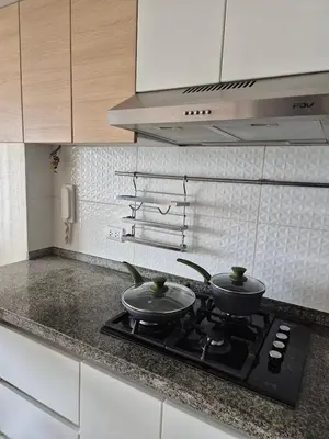two pots on a stove top in a kitchen at Panoramic view apartment in Lima