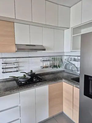 a kitchen with white cabinets and a stove top oven at Panoramic view apartment in Lima