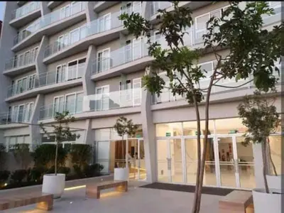 a large building with windows and trees in front of it at Panoramic view apartment in Lima