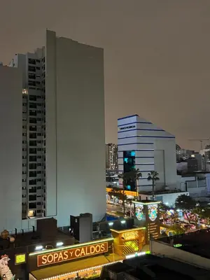 a view of a city at night with buildings at Mar Private Rooms in Lima