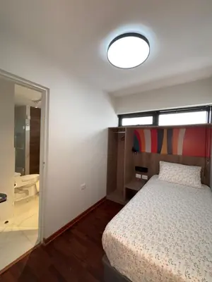 a bedroom with a bed and a large mirror at Mar Private Rooms in Lima
