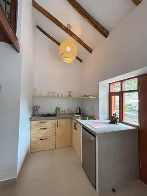 a kitchen with a sink and a counter top at Chaqra in Urubamba