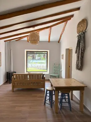 a dining room with a wooden table and benches at Chaqra in Urubamba