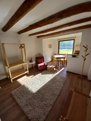 a living room with a table and a rug at Chaqra in Urubamba