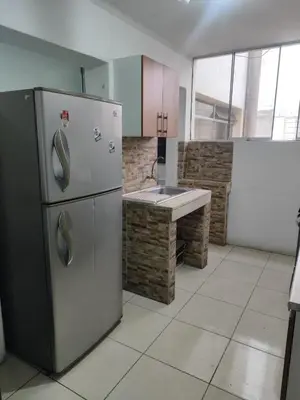 a kitchen with a stainless steel refrigerator and a bench at Miraflores apartment near Larcomar in Lima