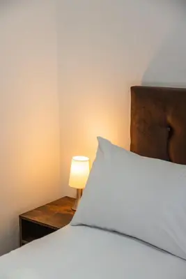 a bedroom with a bed and a lamp on a table at Elmora 2BR by Geko in Lima